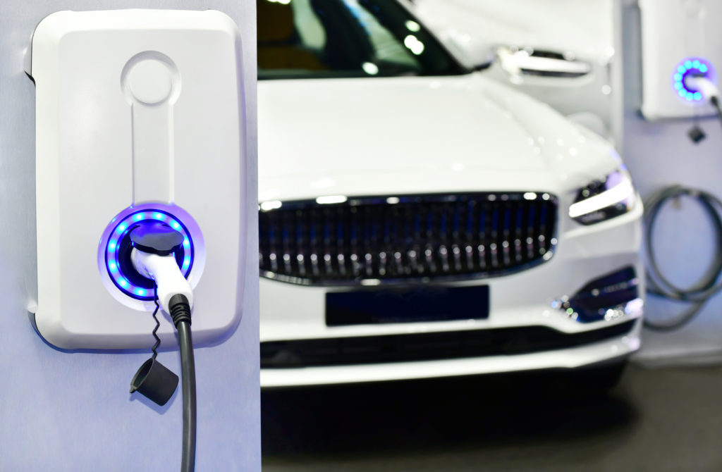 electric vehicle charging station with power supply plugged